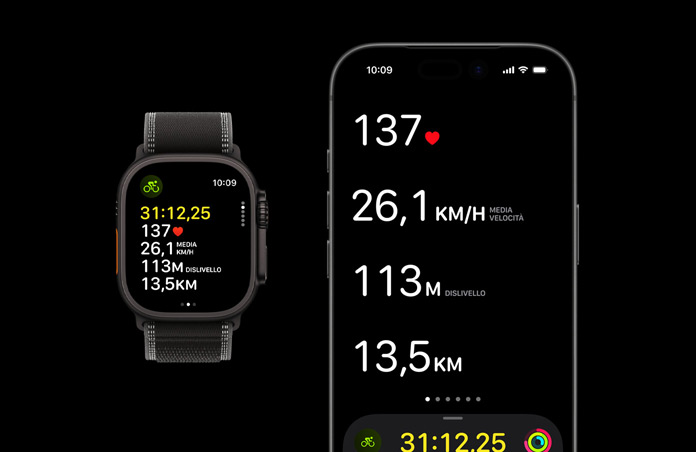 Apple Watch Ultra 3, cassa in titanio nero, cinturino Trail Loop nero e cenere, iPhone, parametri dell’allenamento in corso aperti su entrambi i dispositivi