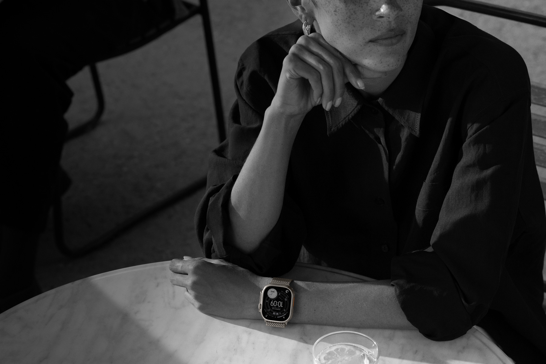 Iemand draagt Apple Watch Ultra 3 in een restaurant