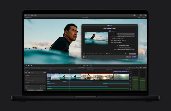 MacBook Pro 16 screen showing image of surfer in ocean waiting for a wave, export file window open, video clip timeline at the bottom of the screen