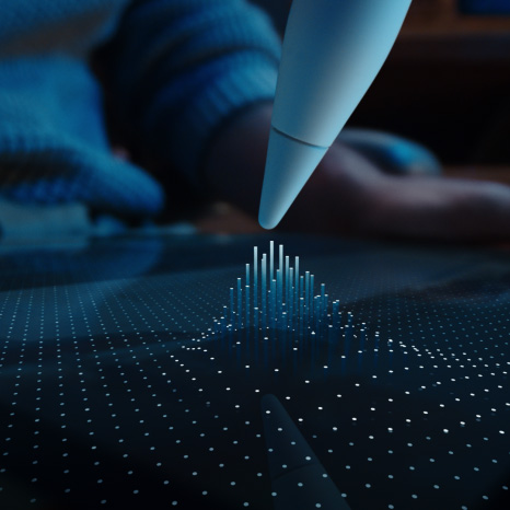 Apple Pencil Pro, white colour, tip of device hovering on iPad display showing a grid of dots with some rising into columns toward the Apple Pencil Pro tip