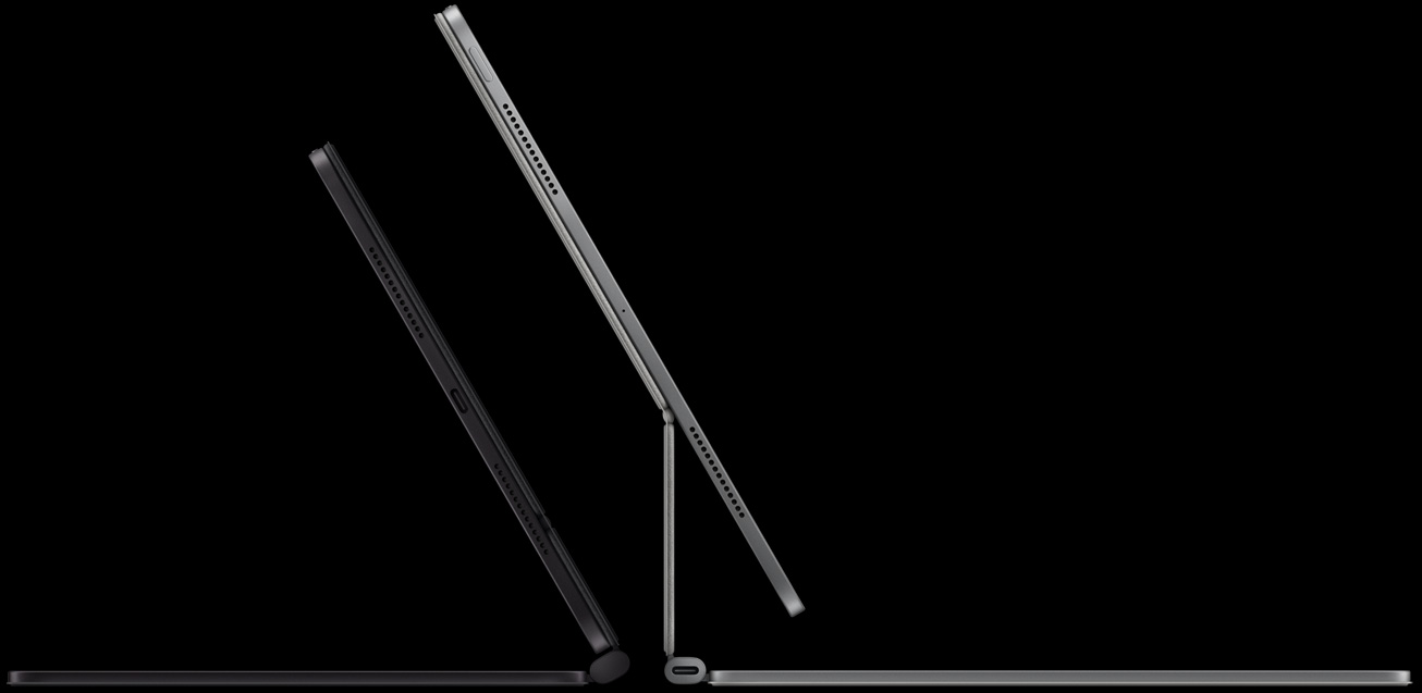 Two iPad Pro devices attached to Magic Keyboard, left: iPad Pro, side exterior, space black colour, microphones, attached to Magic Keyboard, side exterior, space black colour, thin profile, iPad Pro tilted at 45-degree angle, right: iPad Pro, side exterior, silver colour, microphones, attached to Magic Keyboard, side exterior, silver colour, iPad Pro tilted at 45-degree angle showing the keyboard’s floating cantilever design and USB-C connector