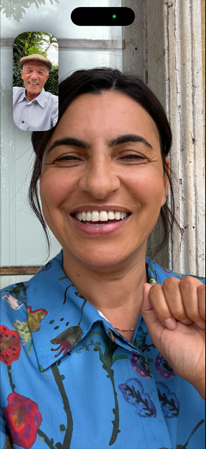 iPhone 17 front screen showing Centre stage for video calls feature as two friends talk