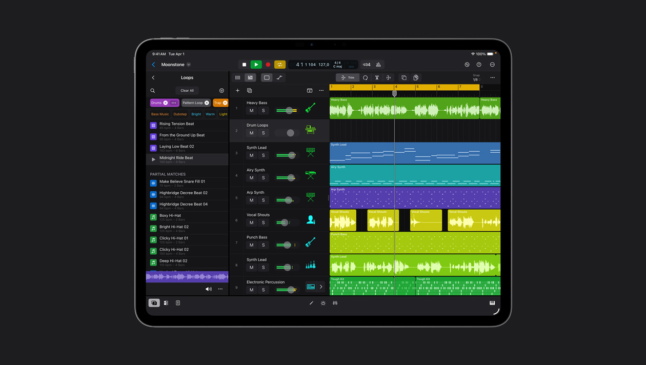 iPad Pro 13″ screen showing Logic Pro workspace, Loops panel to the left, rows of sound waves in different colours