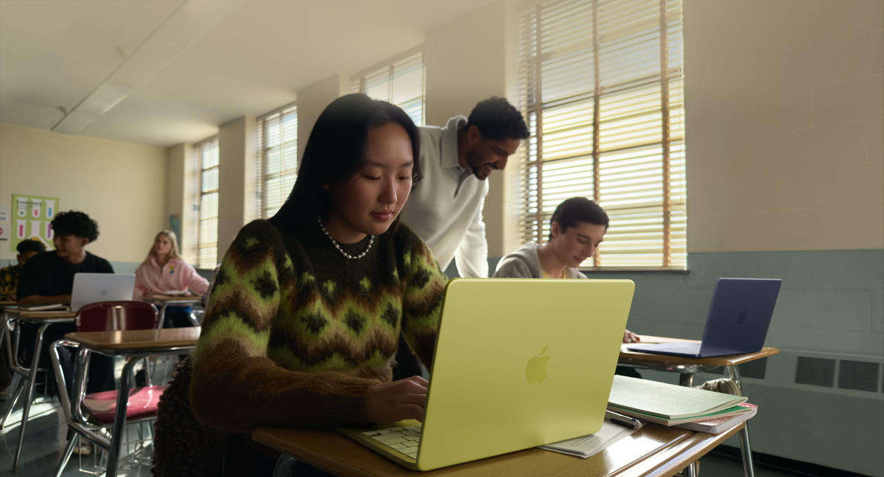 A student uses MacBook Neo, citrus colour, unplugged in a classroom setting
