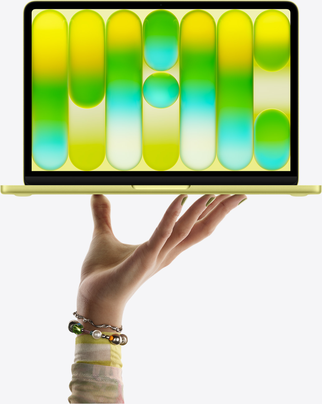 MacBook Neo in citrus colour, balanced on fingertips of open hand, screen displaying colourful abstract pattern