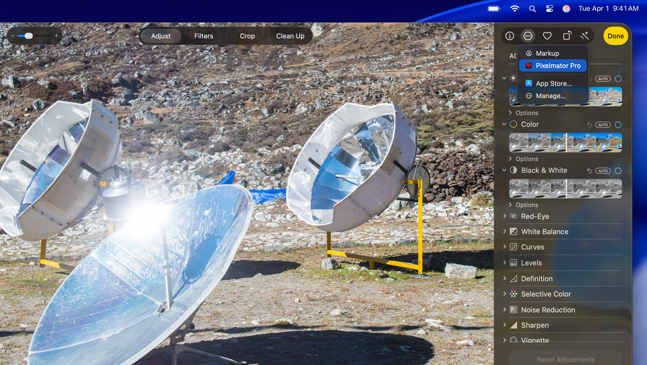 MacBook Pro 16″ screen, photo of three silver space telescopes on ground, image editing tools