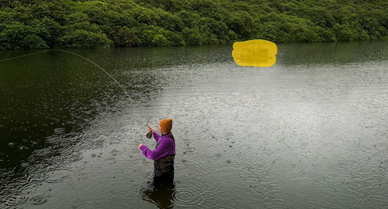 Photo of a woman fly fishing in a lake, Pixelmator Pro tool removing unwanted object in the background being highlighted in yellow